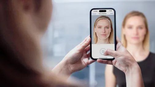 A woman is being photographed with a smartphone.